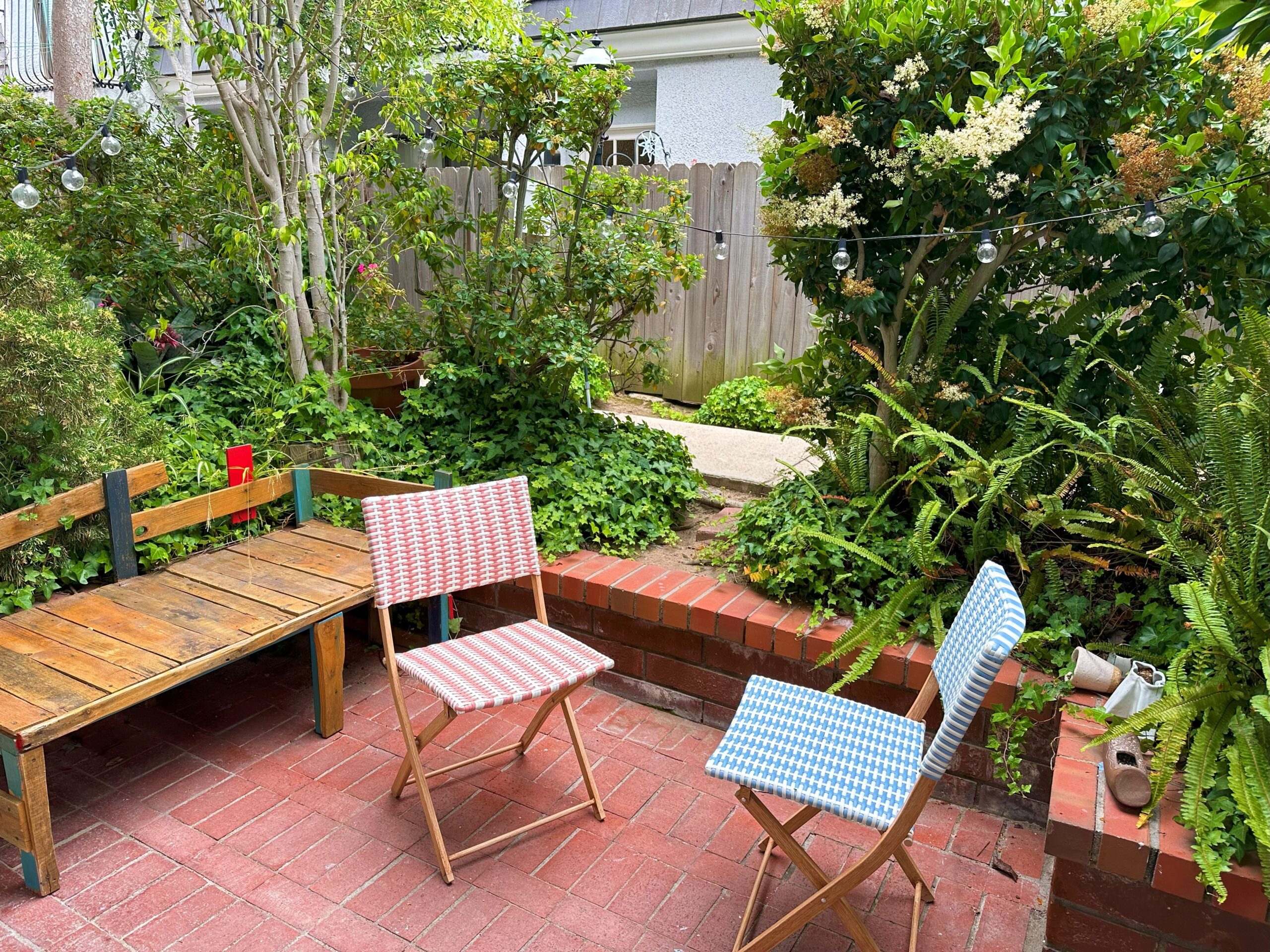 Two chairs are sitting on a brick patio.