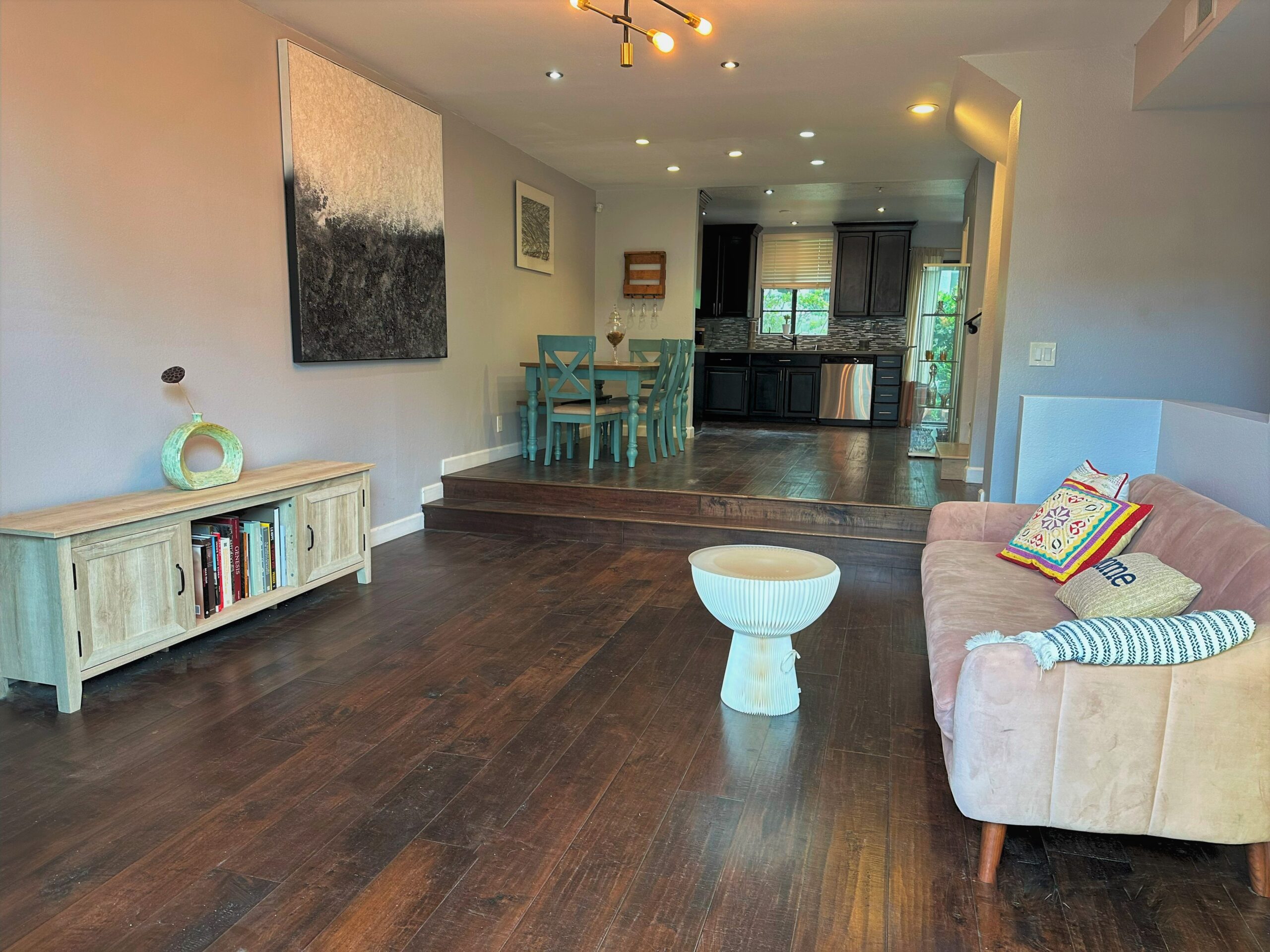 A living room with wooden floors and white walls.