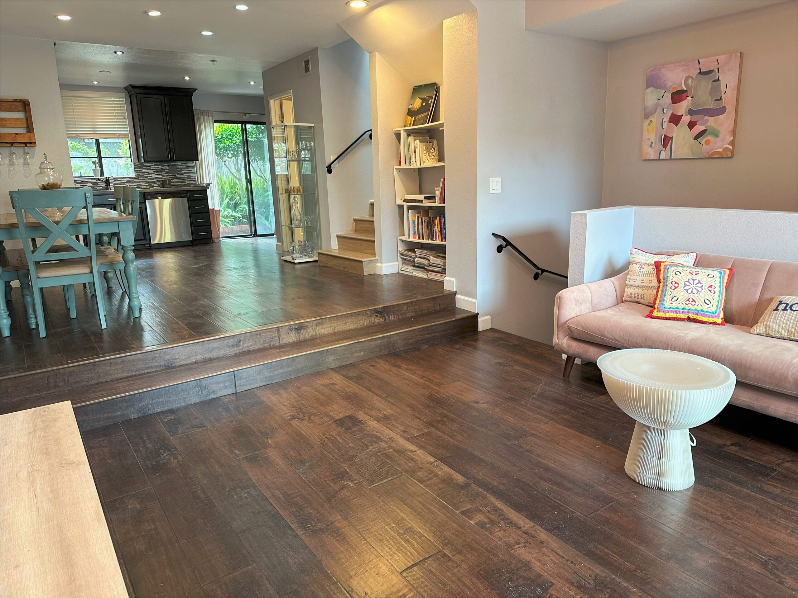 A living room with hard wood floors and a white couch.