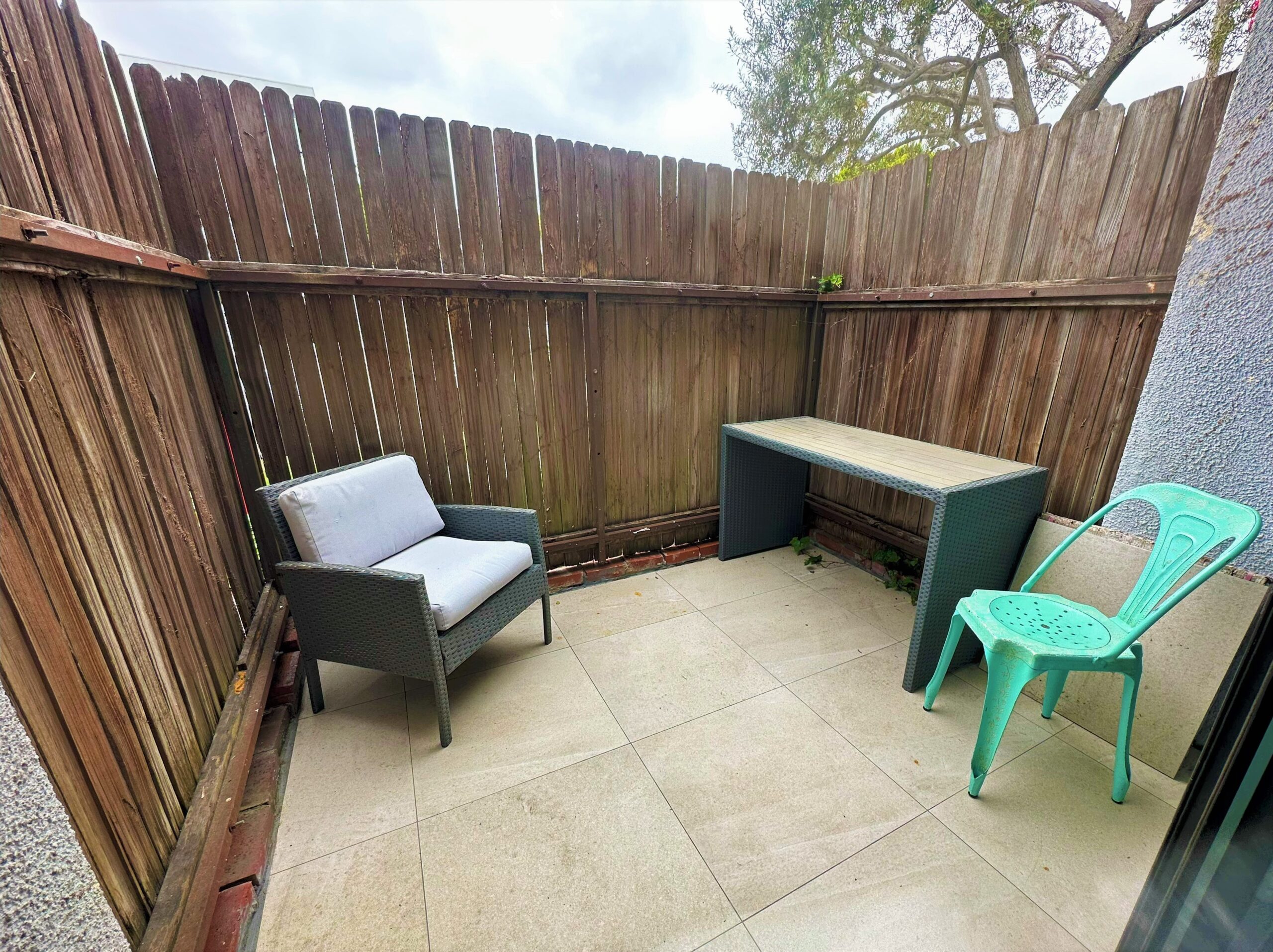 A small patio with chairs and a table