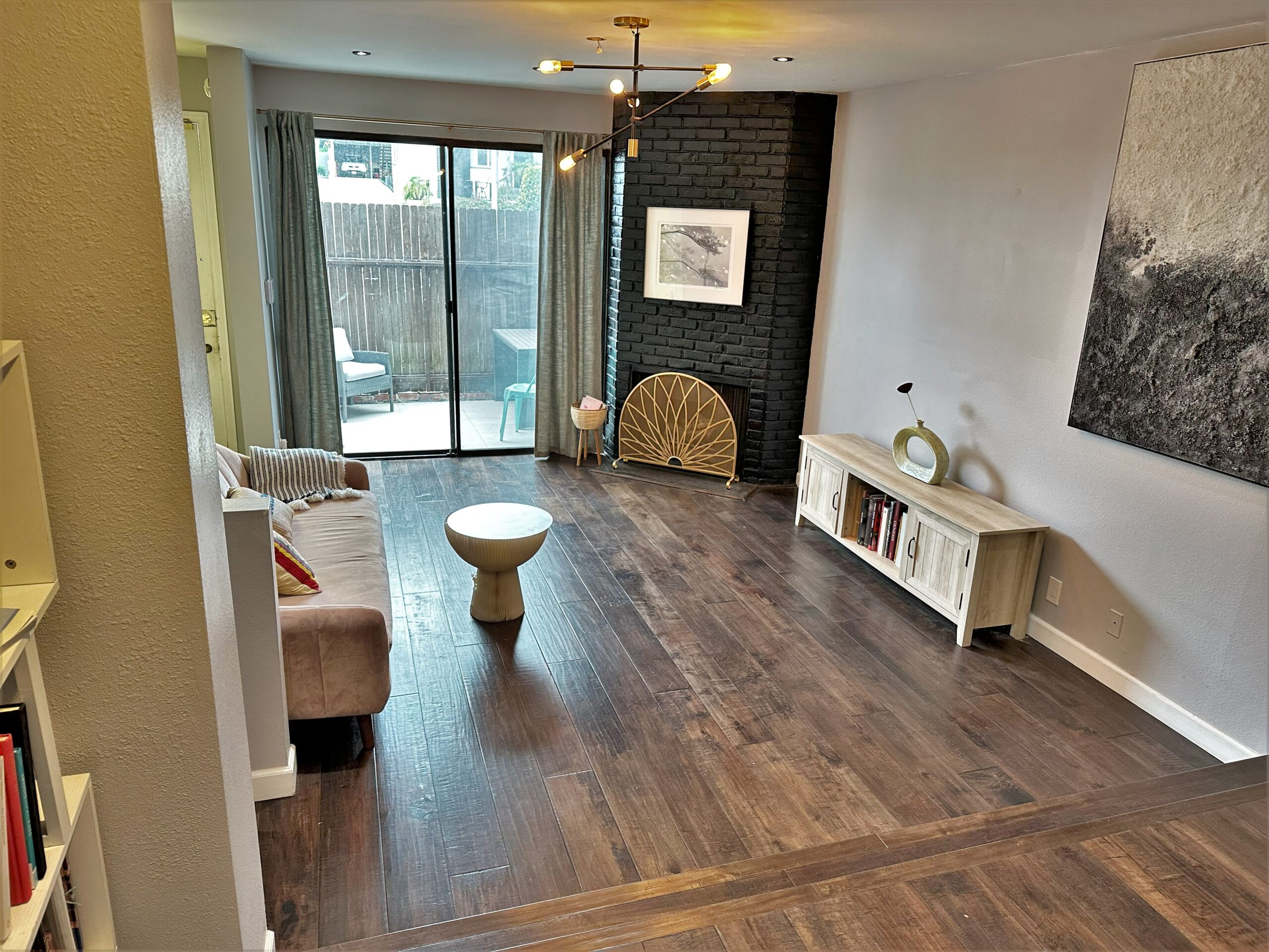 A living room with hardwood floors and a couch.