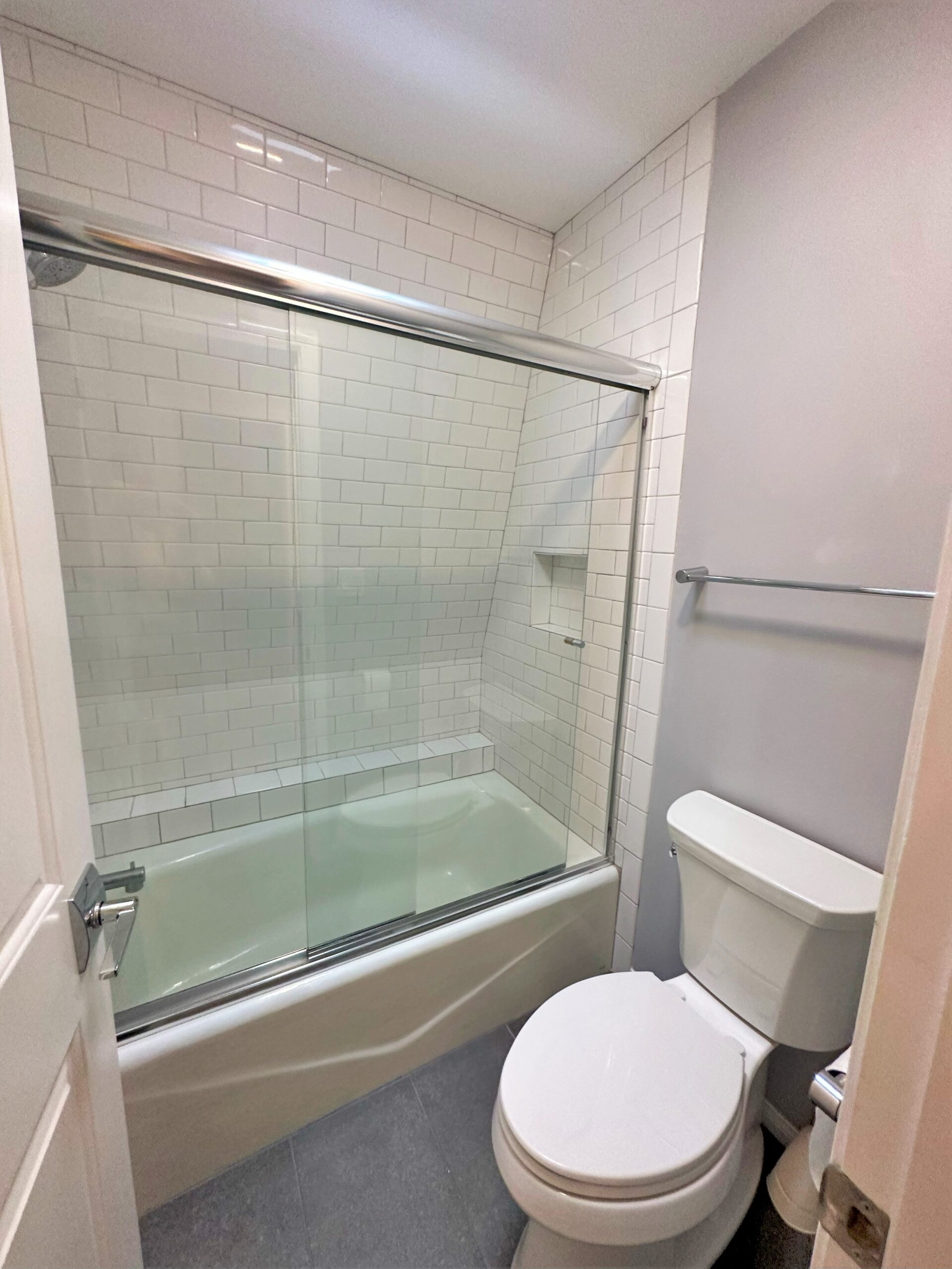 A bathroom with a toilet and tub in it