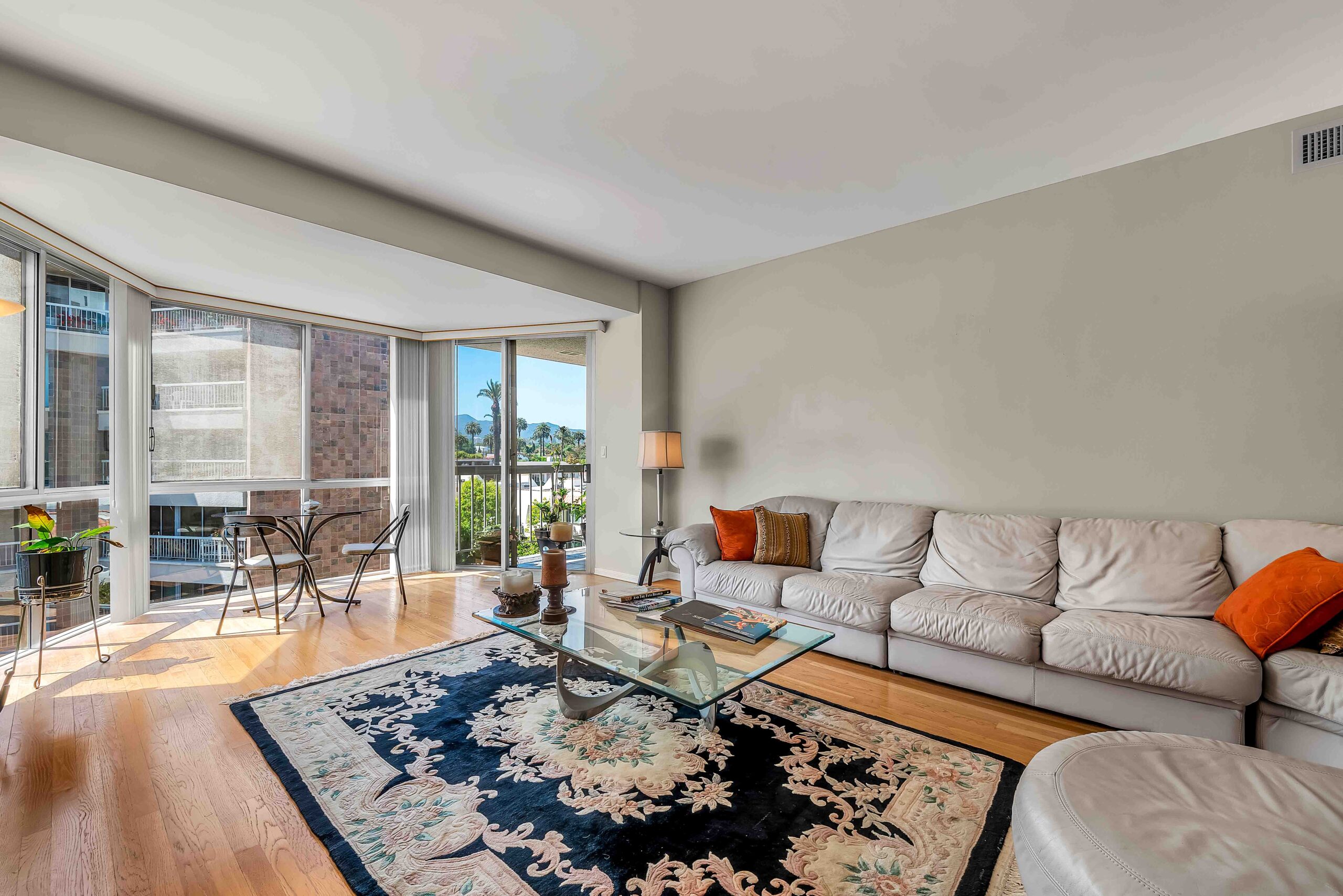 A living room with a couch, table and chair.