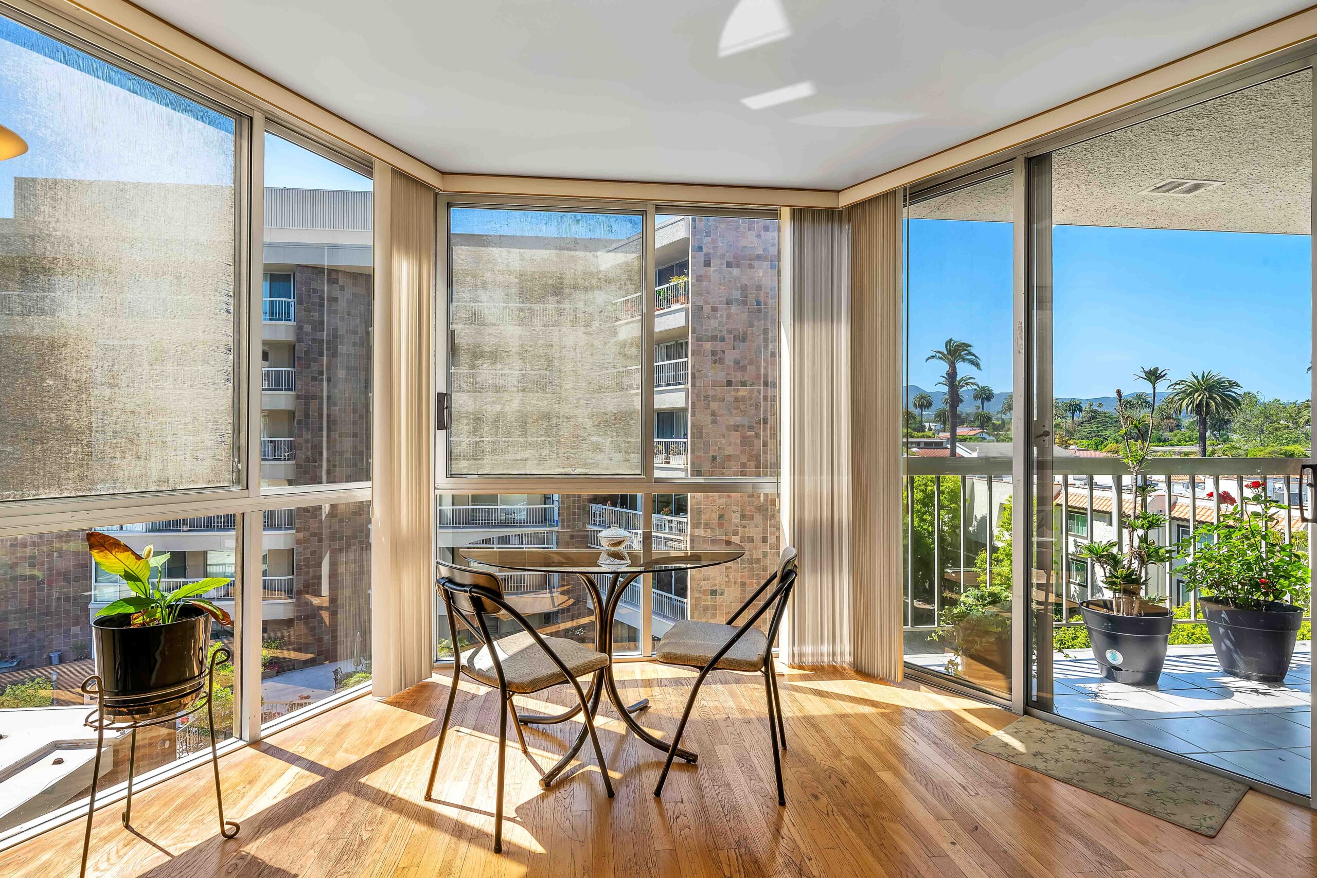 A table and chairs in the middle of an open living room.