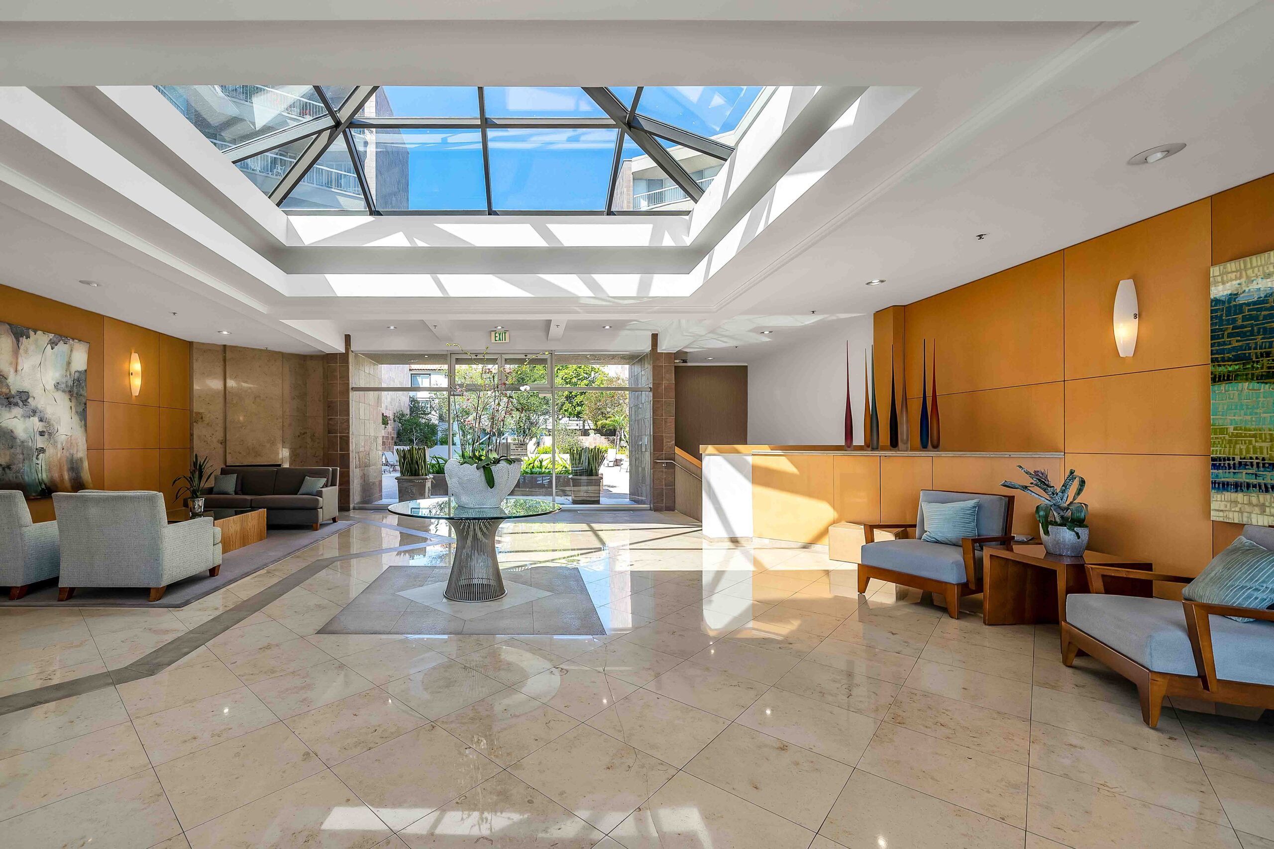 A large room with a skylight and marble floors.