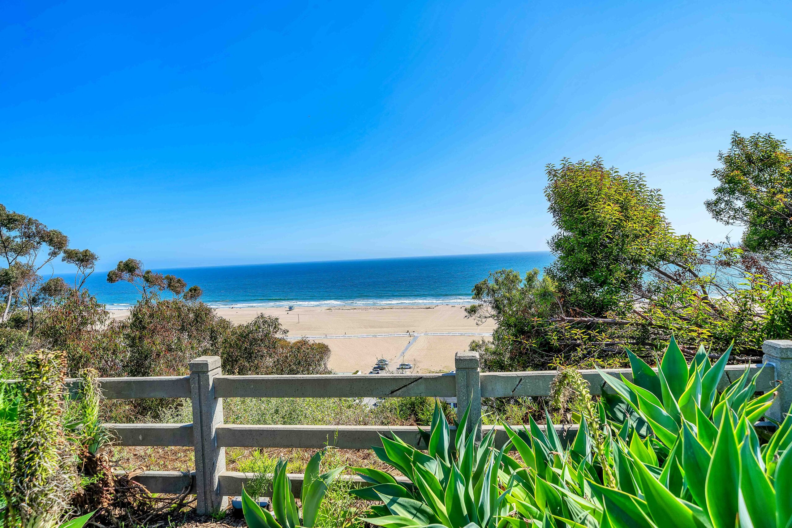 A fence that is in front of the ocean.