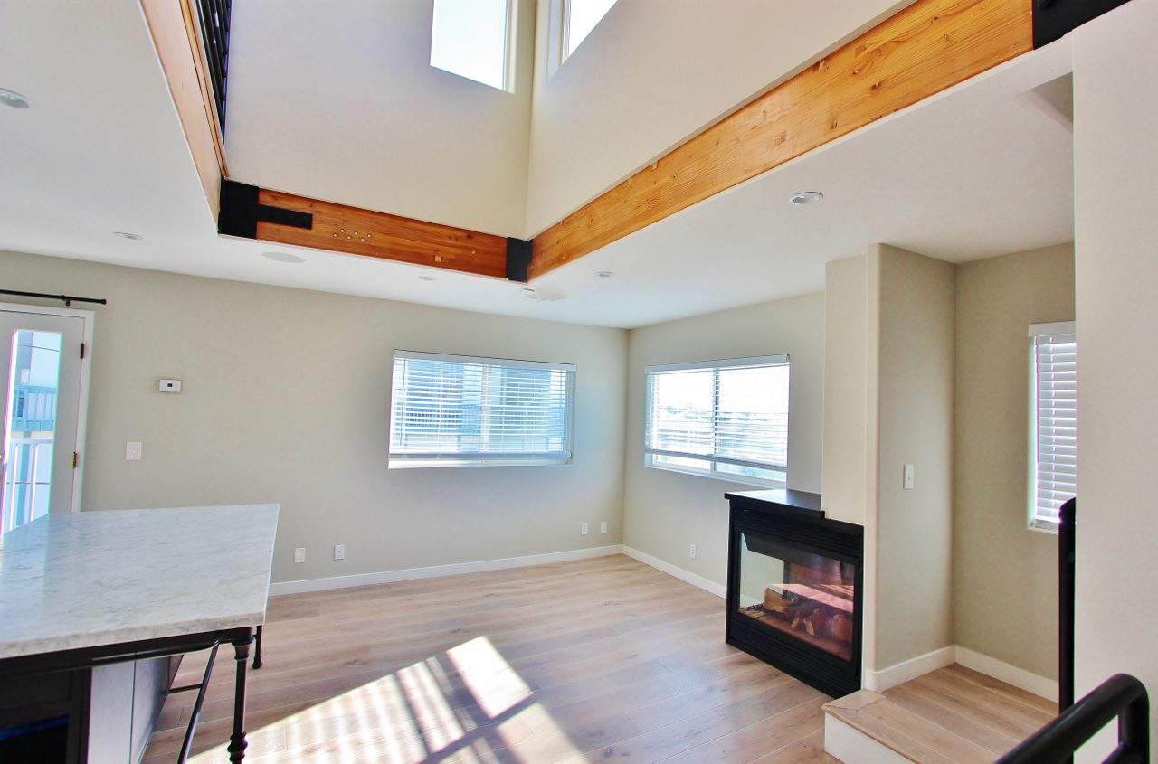 A living room with a fireplace and a table