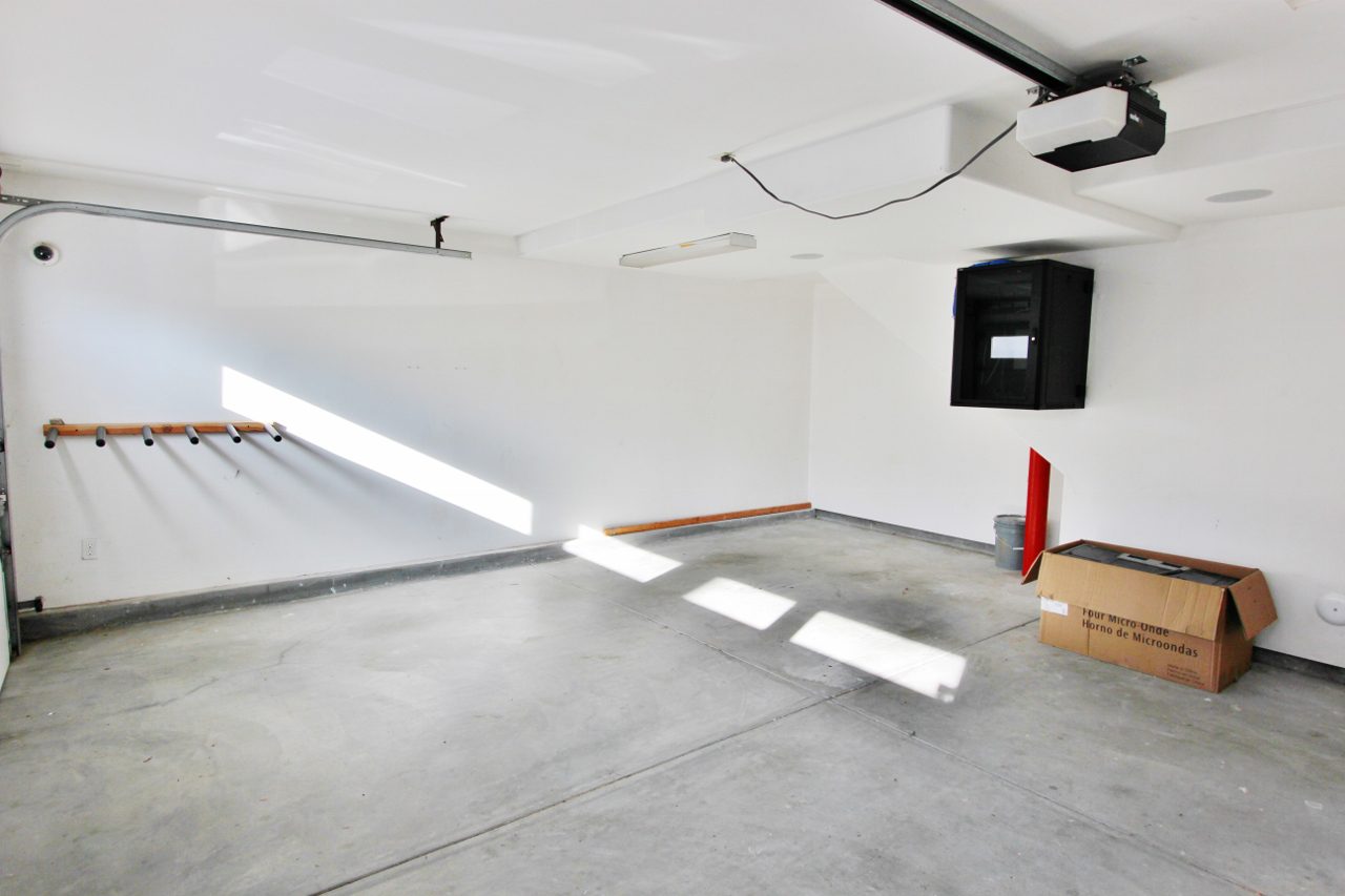 A garage with concrete floors and white walls.