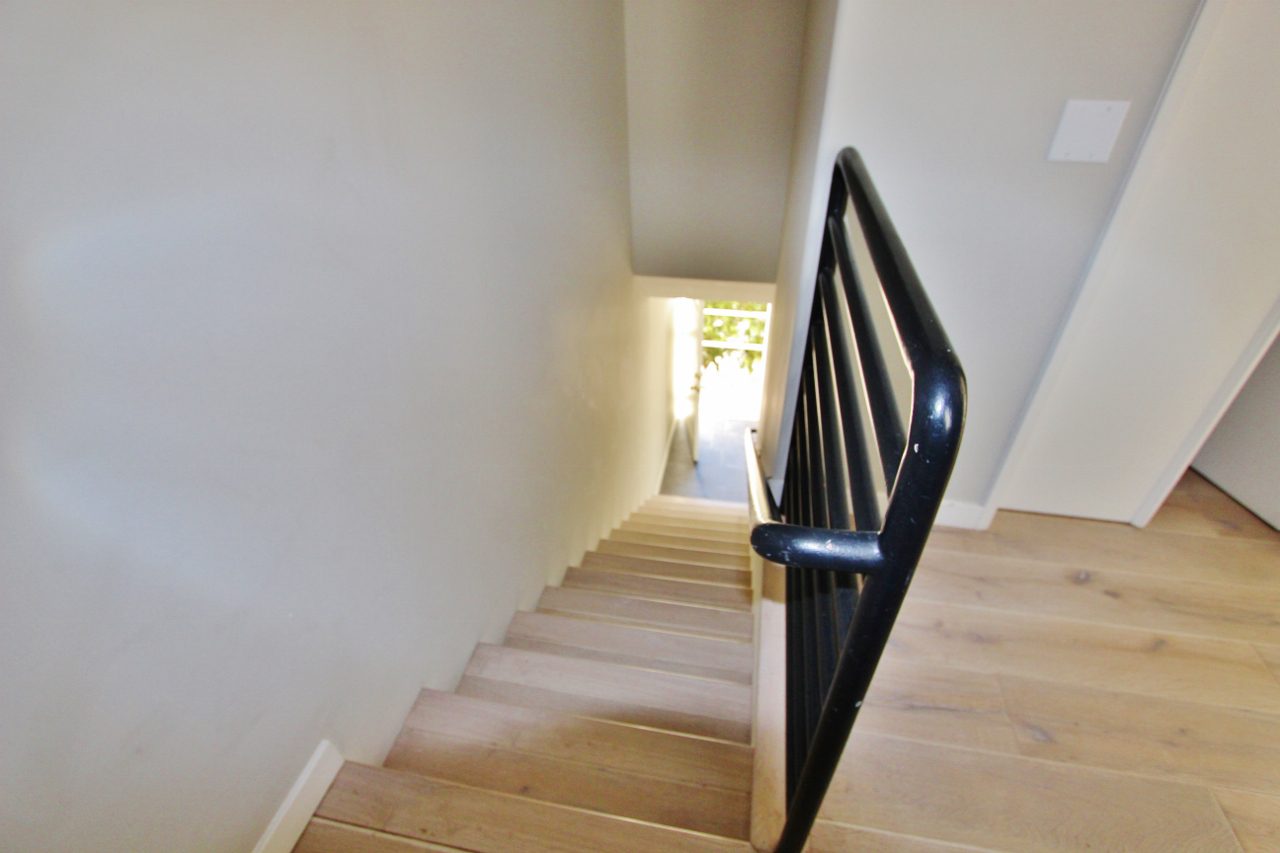 A view of the bottom part of stairs from above.