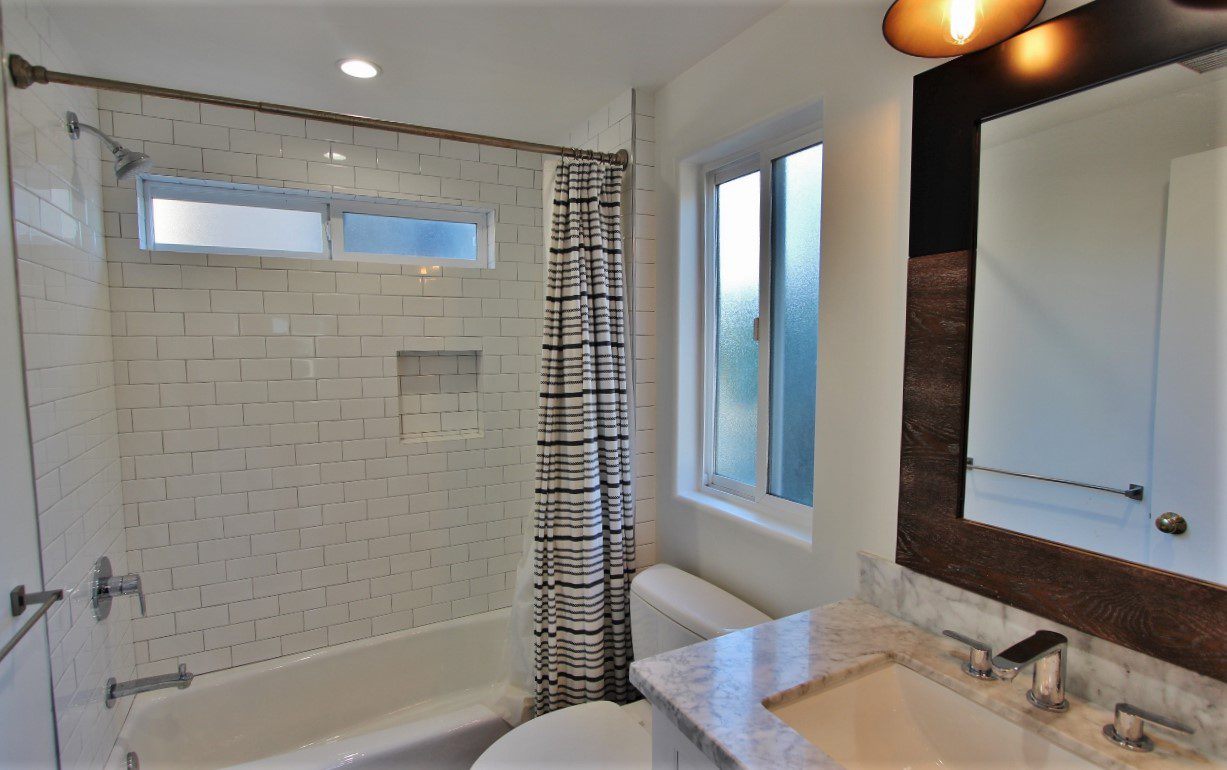 A bathroom with a sink, toilet and bathtub.