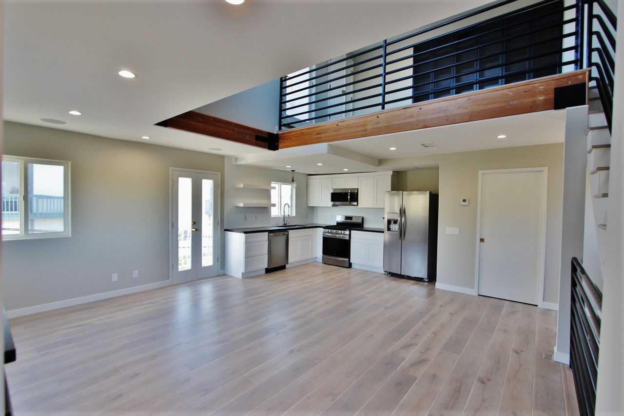 A large open floor plan with a kitchen and living room.