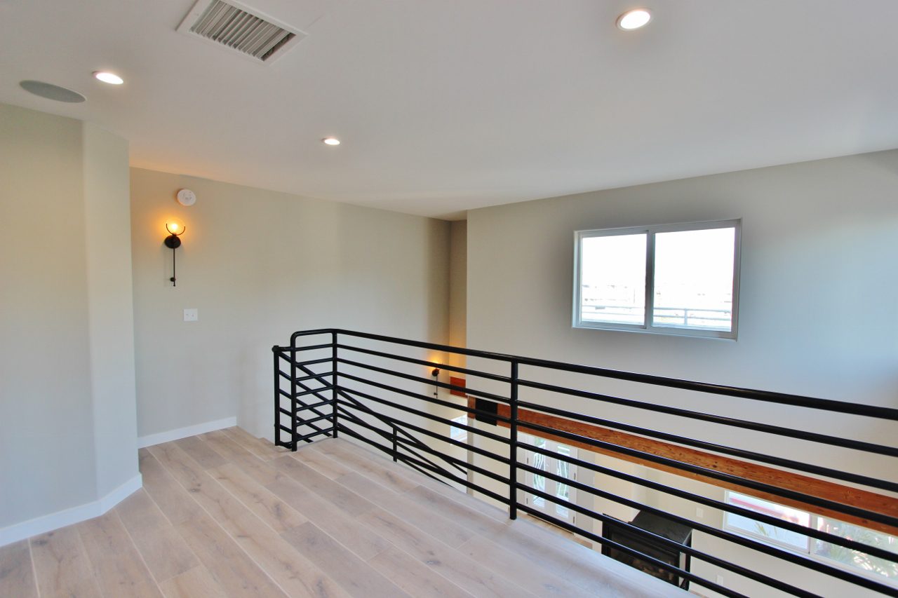 A room with a railing and a window.