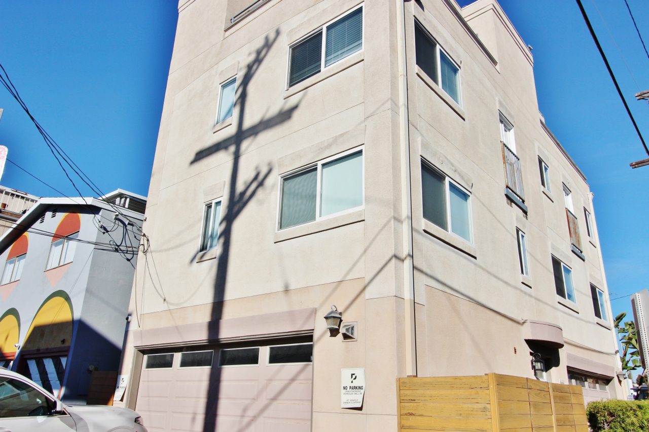 A building with a wooden pole in front of it.