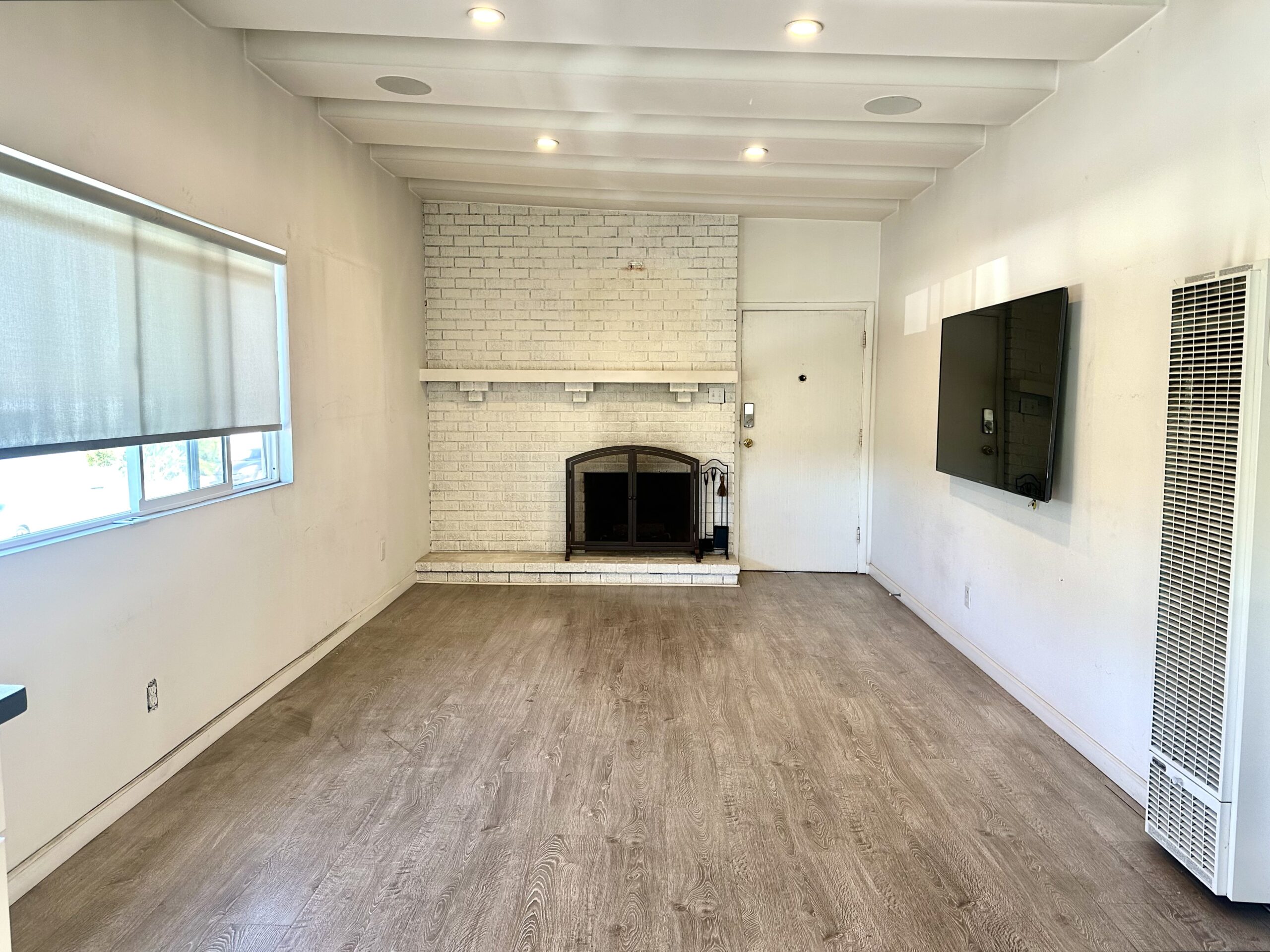 A room with a fireplace and a television.