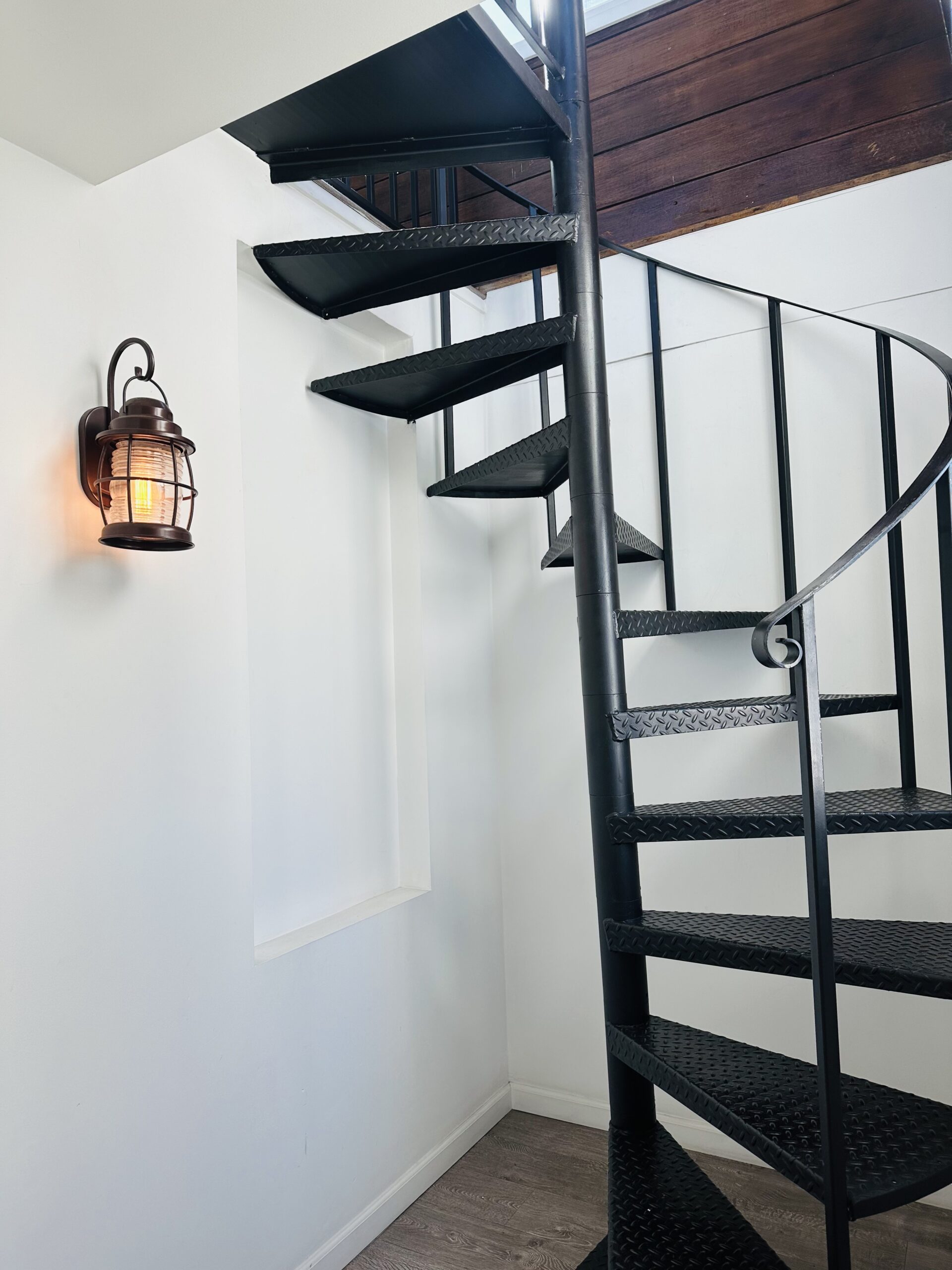 A staircase with metal steps and black painted treads.