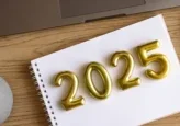 Golden balloon numbers '2025' on a notebook page.