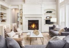 Cozy modern living room with a lit fireplace and neutral tones.